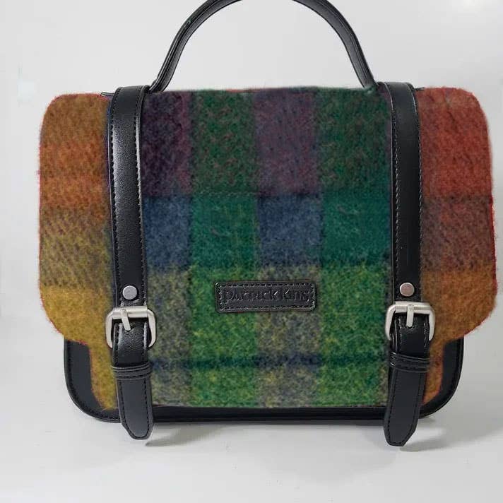The Antique Buchanan Small Handbag is a satchel-style Scottish bag with a multicolored Buchanan Tartan wool exterior, black leather straps and handle, and a Patrick King label on the front.