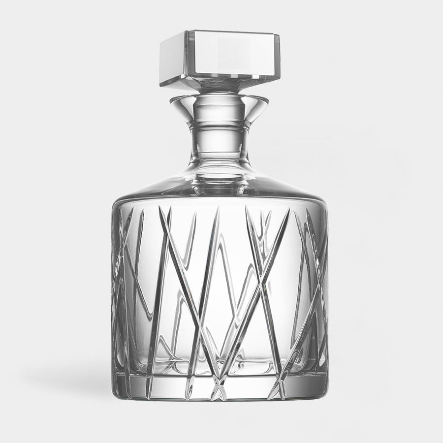 The Orrefors: City Decanter 32oz showcases a stunning geometric design in crystal glass with a sleek square stopper, set against a plain white background.