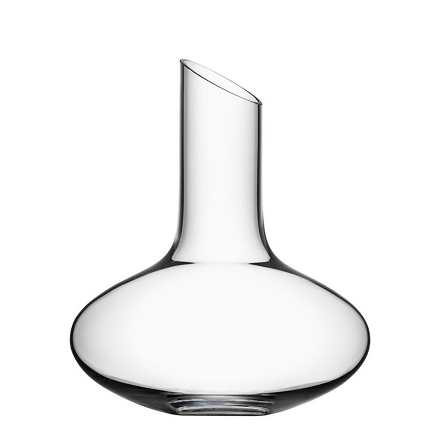 The Orrefors Enjoy Decanter 34oz, designed by Erika Lagerbielke, showcases a clear glass body with a wide base and narrow, slanted neck, set against a white background.