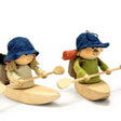 The 5-inch Scandinavian Hiking Boy in Kayak Figurine features a boy with a blue hat and backpack paddling a wooden kayak, making it a charming handcrafted ornament for your Nordic Christmas decor.