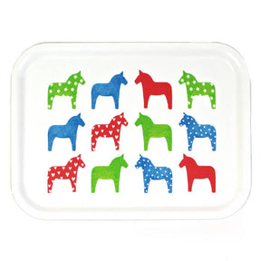 The Tray: "Dalahast" Dala Horse Decorative Tray (3"x11", birch veneer) is made in Sweden and features twelve white stylized horses with hearts, polka dots, and stars in green, blue, and red.