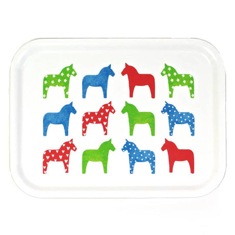 The Tray: "Dalahast" Dala Horse Decorative Tray (3"x11", birch veneer) is made in Sweden and features twelve white stylized horses with hearts, polka dots, and stars in green, blue, and red.