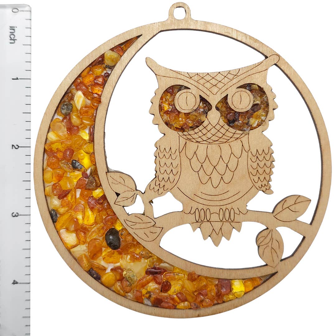 Ornament: Owl Amber Suncatcher/Magnet features a wooden owl on a crescent moon with gleaming Baltic amber stones, including a side ruler for scale to showcase its intricate charm.