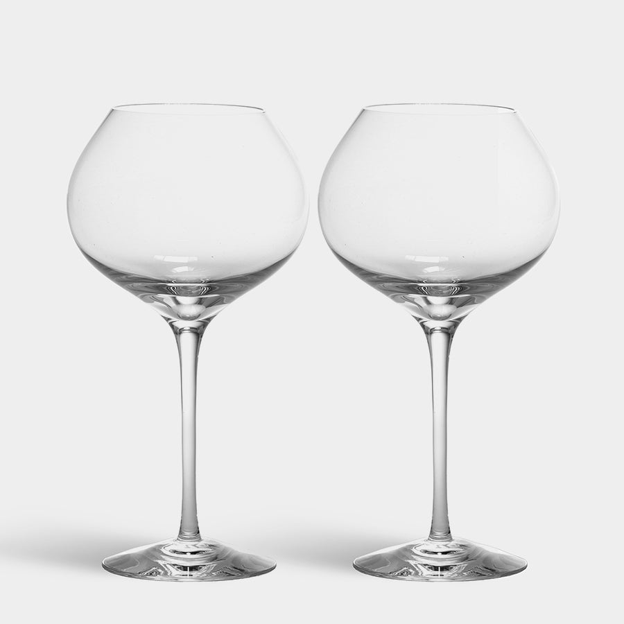 Two Orrefors Difference Mature Glasses (22oz, 2-Pack), evocative of Erika Lagerbielke’s elegant designs, are positioned side by side against a plain background.