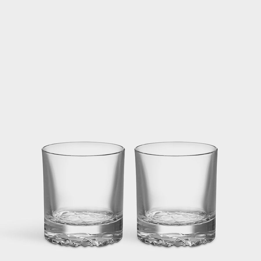 Two Orrefors Carat Double Old Fashioned crystal tumblers with thick bases stand elegantly against a plain white background.