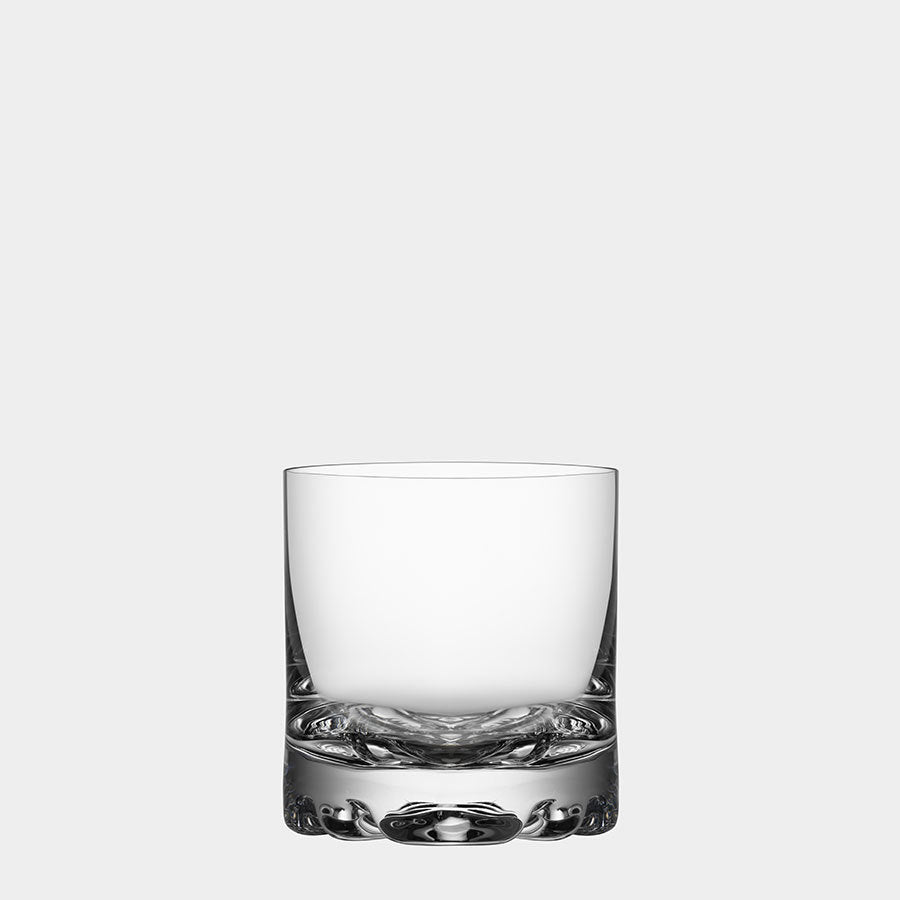 The Orrefors Erik Double Old Fashioned Glass 12oz showcases a clear design and thick base, epitomizing Scandinavian elegance against a plain, light gray background.