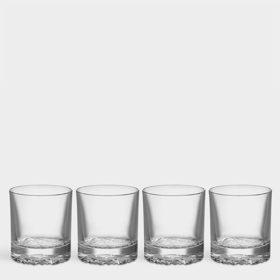 Four clear Orrefors: Carat Double Old Fashioned glasses with textured bases are aligned in a row on a plain background.