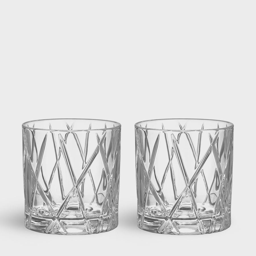 The Orrefors City Double Old Fashioned Glass 11oz (2-Pack) includes two crystal whiskey glasses with a geometric diagonal cut pattern on a plain background, reflecting elegance.