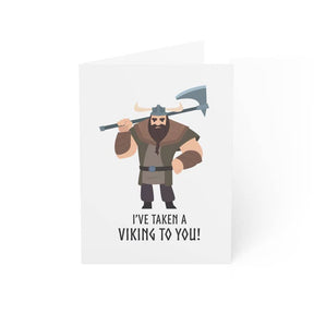 The "I’ve Taken a Viking to You (Male Viking)" greeting card features a cartoon Viking with an axe and the phrase "I'VE TAKEN A VIKING TO YOU!"—a fun Valentine’s Day card, blank inside for your own message.