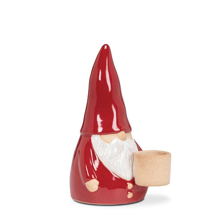 Tomte Santa Taper Holder, a 5-inch ceramic piece featuring a gnome-like character with a tall red hat and white beard, holding a small cup.