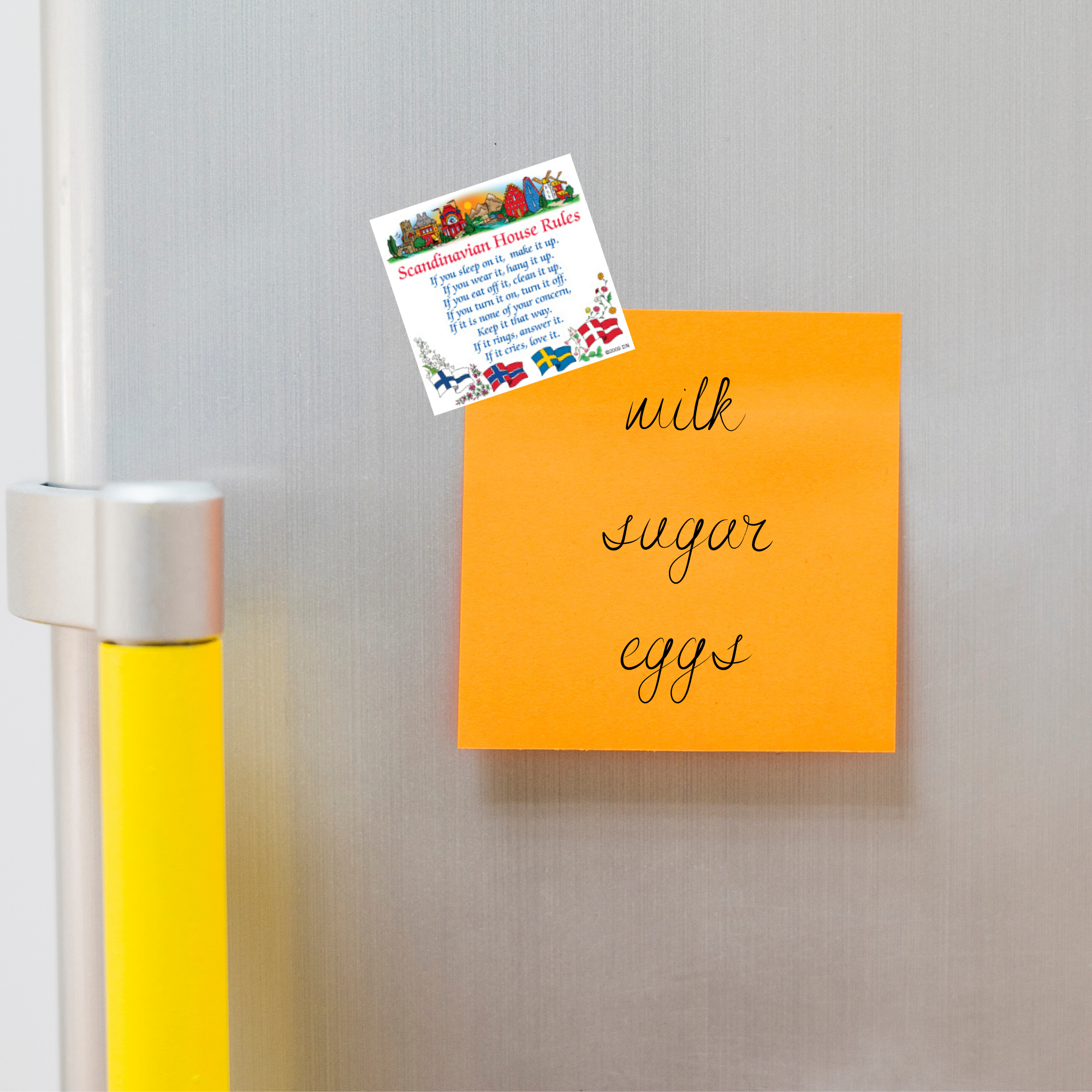 An orange sticky note on the fridge lists milk, sugar, and eggs. Above it is a Scandinavian gift—a Magnet: Swedish Gift Idea Magnet Tile House Rules with colorful designs—adding charm to the kitchen's decor.