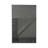 A folded unisex 100% baby alpaca scarf in carbon charcoal color, featuring fringed edges and a striped pattern with two shades of gray on one end.