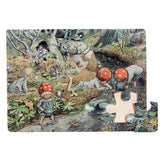 A nearly complete Puzzle - Elsa Beskow "Children of the Forest" Wood Frame Puzzle shows children in red toadstool caps by a forest stream. One piece is missing from the bottom right corner of this charming Scandinavian illustration.