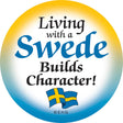 Show your Swedish pride with this 2" metal pin-back button featuring a yellow-to-blue gradient, Swedish flags, and "Living with a Swede Builds Character" in bold—perfect for festivals!.