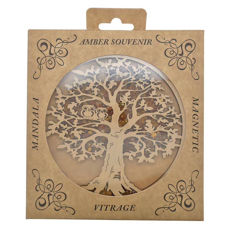 The cardboard packaging, adorned with a tree design and labeled Amber Souvenir, Mandala, Magnetic Vitrage, includes a decorative cutout showcasing the Tree of Life Ornament: an Amber Suncatcher crafted with Genuine Baltic Amber and featuring Two Owls set in a Wooden Tree.