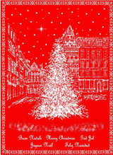 The Holiday European Village Woven Jacquard Tea Towel (20 x 28) features a festive town square Christmas tree scene with stars and Merry Christmas in multiple languages on red woven cotton.