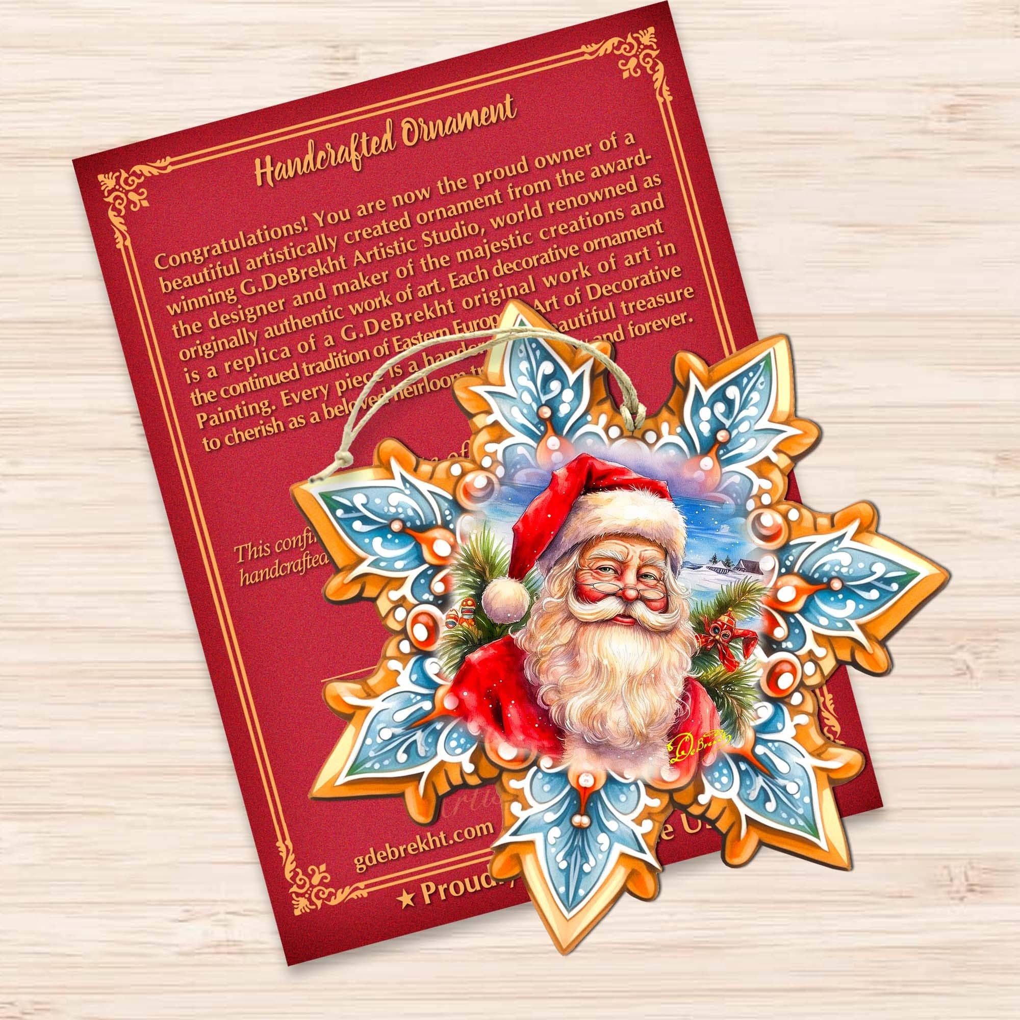 Introducing the Santa Snowflake Wood Ornament by G. Debrekht! This star-shaped ornament features a depiction of Santa Claus amidst holly and snowflakes, handcrafted in the classic G. Debrekht style. It comes complete with a red certificate of authenticity, elegantly displayed on a wooden surface. Ideal for bringing festive cheer to your Christmas décor.