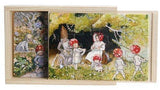A wooden box holds four Elsa Beskow "Children of the Forest" tray puzzles, with charming nature-themed scenes ready to explore.
