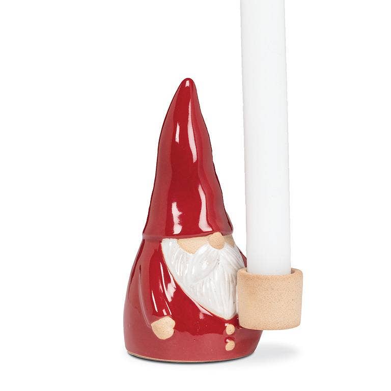 Introducing the Tomte Santa Taper Holder, a 5-inch ceramic candle holder resembling a gnome-like Santa with a red hat and designed to hold a white taper, ideal for enhancing your holiday decor.