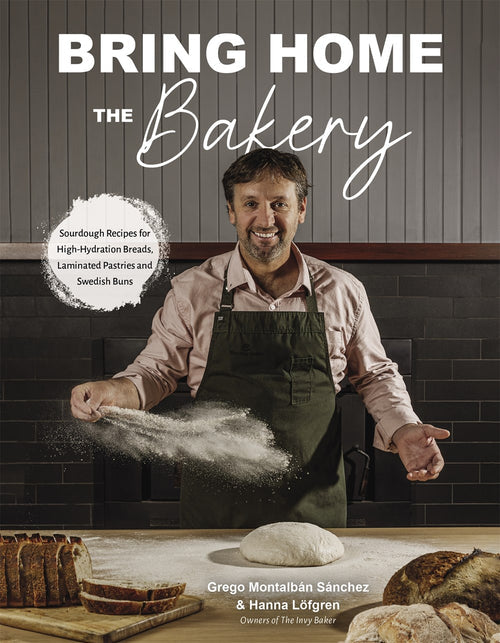 A smiling man in an apron sprinkles flour over dough with artisan breads and Swedish buns nearby, beneath the title Book: Bring Home the Bakery Sourdough Recipes for High Hydration Breads, Laminated Pastries and Swedish Buns by Grego Montalban Sanchez & Hanna Lofgren.