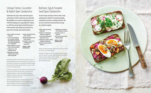 Two Scandinavian open sandwiches—one with cottage cheese, cucumber, radish; the other with beetroot, egg, pumpkin seeds—sit on a plate with a radish and two forks. Recipes from Book: Smorrebrod Scandinavian Open Sandwiches Bronte Aurell inspire Nordic fare.