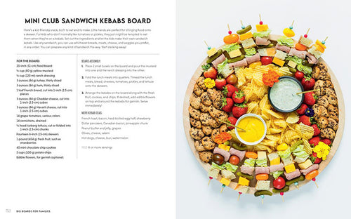 A circular food board overflowing with skewered sandwiches, chips, vegetables, and dips is ideal for family meals. Check out "Book: Big Boards for Families" for hosting tips and a detailed recipe with instructions on the adjacent page.