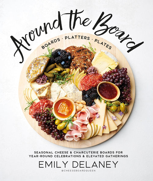 A round platter filled with a variety of cheeses, meats, fruits, and nuts is ideal for entertaining. The text is taken from "Around the Board" by Emily Delaney.