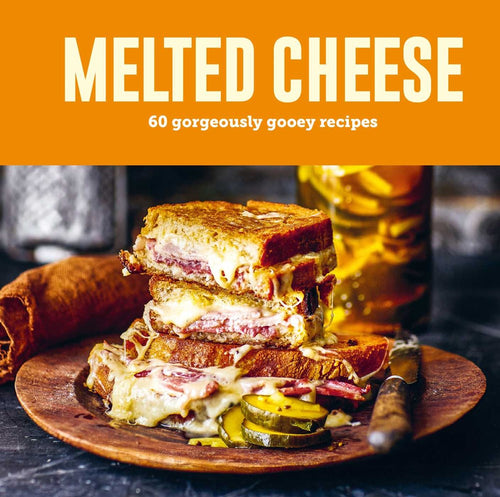 Enticing stacked grilled cheese sandwiches with pickles sit on a wooden plate, knife in place. Above reads Book: Melted Cheese 60 Gorgeously Gooey Recipes.