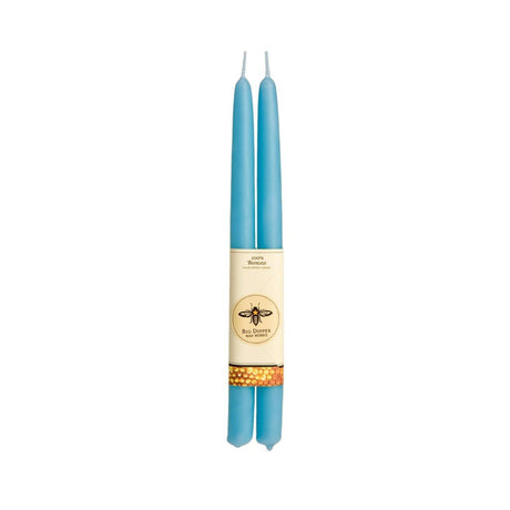 A charming bee logo decorates the label of a Big Dipper Wax Works 100% Beeswax Taper Candle Pair, featuring two elegant blue tapers.