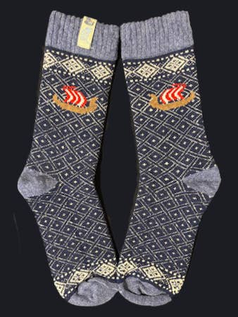 Socks: Viking Ship on Black and Natural Wool by Swedish Passport Co—wool socks with Nordic diamond patterns and a red-white Viking ship, shown side by side on a dark background.