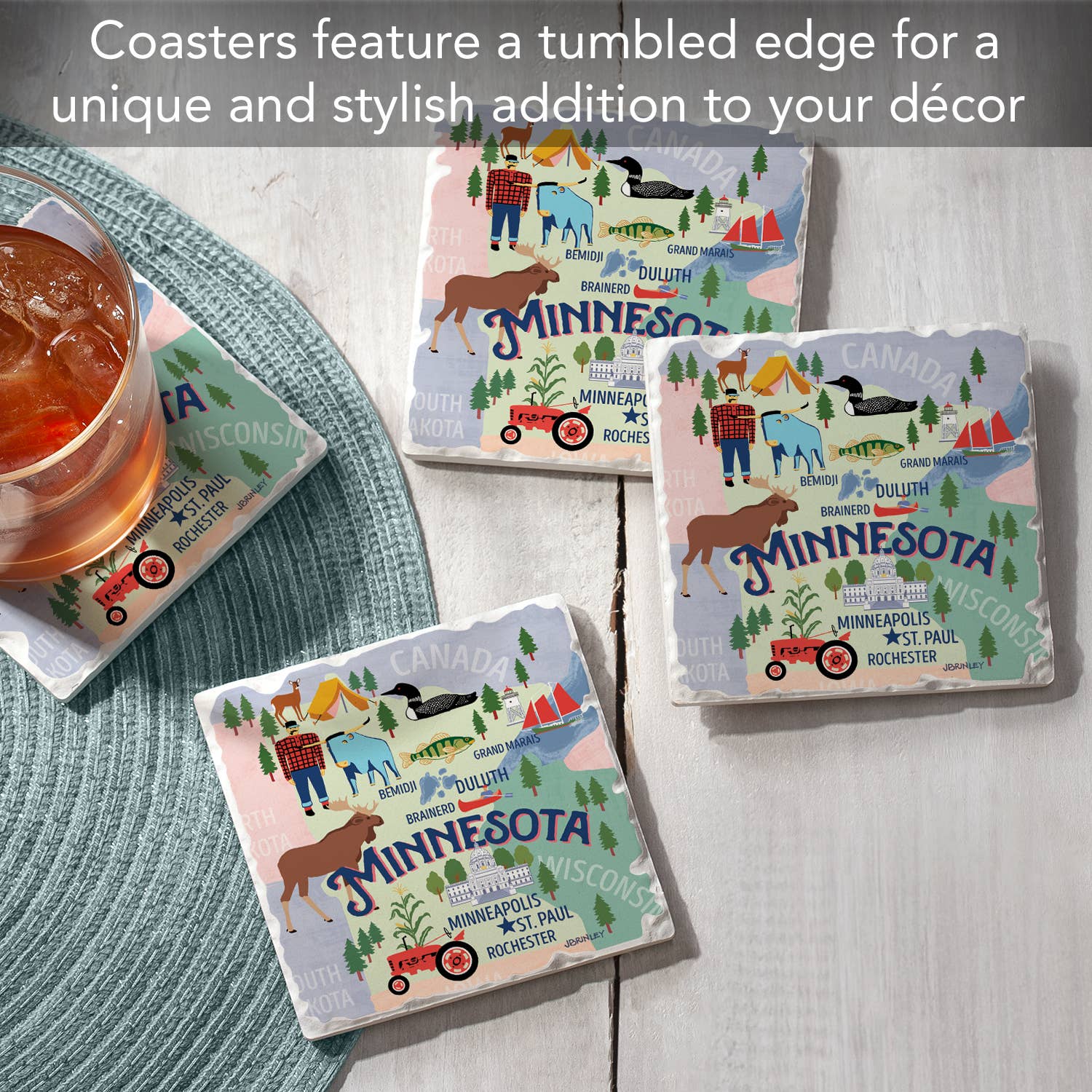 Three Minnesota Attractions Thirsty Stone Coasters with cork backing are on a wooden surface next to an iced tea, featuring tumbled edges.