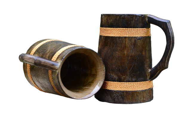 Two Coffee Mugs: Wooden Viking Tankards with a vibrant orange finish (16–18 oz), one upright and one on its side, showcase handcrafted Nordic charm against a clean white background.