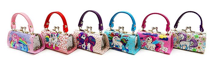 A delightful assortment featuring six vibrant Purse: Unicorn Mini Purses, each with enchanting designs and decorative patterns, and uniquely colored handles.