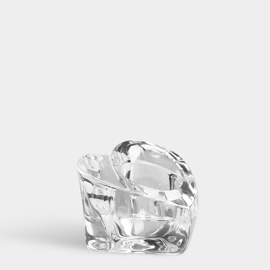 The Orrefors Valentino Votive Clear Candle Holder by Martti Rykonen features a smooth, curved sculptural design and sits on a plain light background.