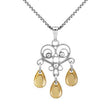 The Sølje Heart Necklace features an 18" sterling silver chain and an ornate filigree heart pendant, inspired by Norwegian jewelry, with three gold teardrop charms.