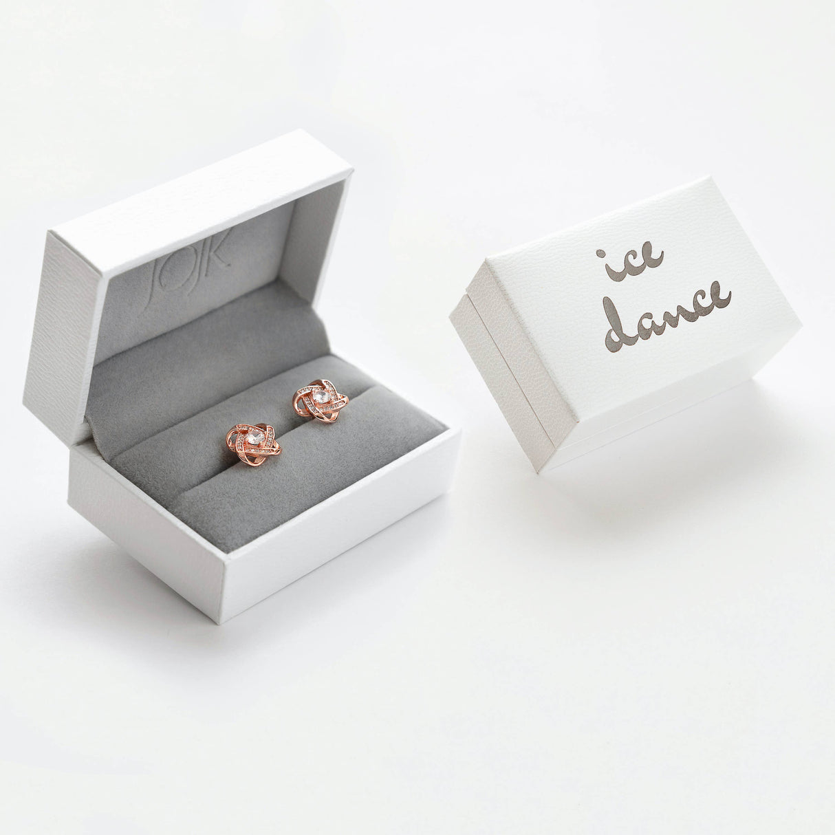 A rose gold and sterling silver Ice Dance necklace with brilliant cut cubic zirconia on an 18 chain is displayed in a white jewelry box, next to a closed box labeled ice dance.