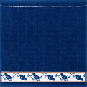 Square cotton towel in dark blue with a horizontal white border patterned with blue birds on branches.