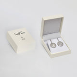 A white JOIK jewelry box rests next to an open box displaying the Earrings: Tree of Life in Sterling Silver with Beautiful Luster on white padding.