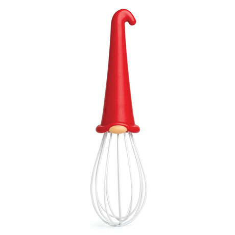 Introducing the OTOTO Whisk: Gnome Wire Whisk—this delightful kitchen helper boasts a red handle shaped like a gnome’s hat, a beige collar, and sturdy white wire loops for mixing. Standing upright on a white background, it adds whimsical flair to any kitchen and makes for a giftable baking tool. When batter needs blending and cream needs whipping, this cheerful gnome spins through the bowl with a hop and a skip!.