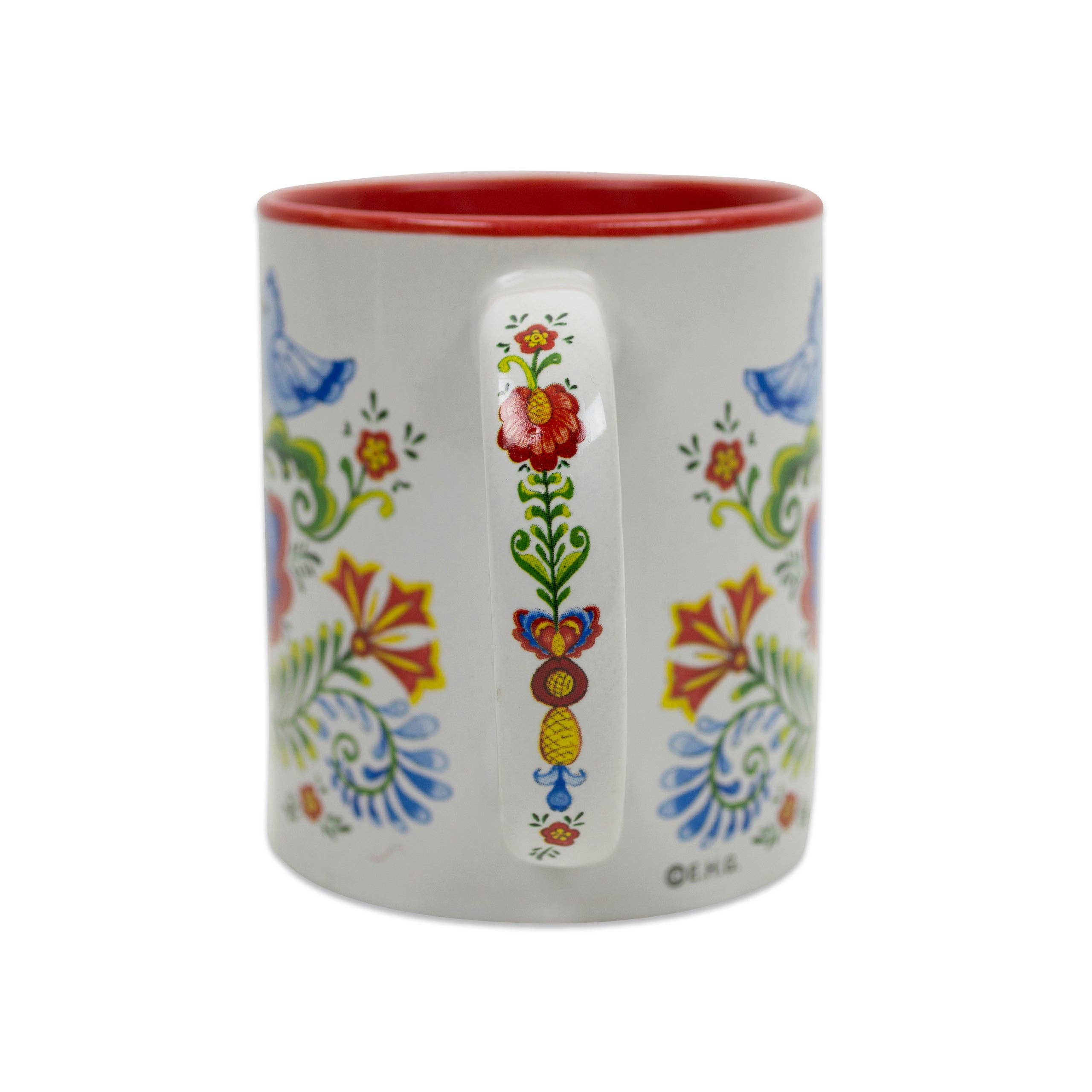 The Mug: Rosemaling & Lovebirds Ceramic Coffee Mug features a white ceramic body with a red interior, decorated in Scandinavian-style floral and bird motifs, and holds 12 oz.