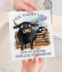 A person holds the Avery Lane Gifts Swedish Dishcloth: Live Today Like You're Getting Grilled Tomorrow Cow, featuring cartoon cows over a fence and the text "Live today like you’re getting grilled tomorrow." Eco-friendly and perfect for your sink.