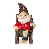 Garden gnome figurine wearing a red shirt and green pants, seated on a wooden chair and holding a green bottle.