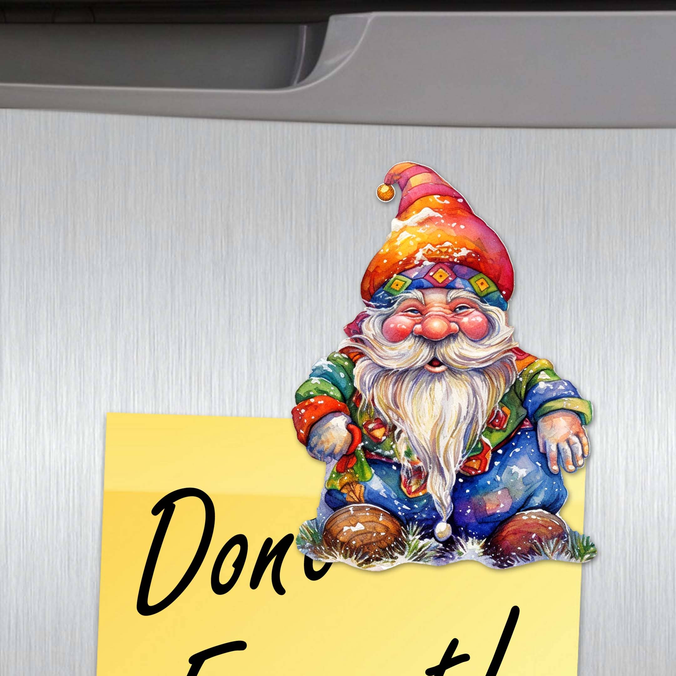 Jolly Gnome Refrigerator Wooden Magnet, handcrafted in America, featuring a colorful gnome holding a yellow sticky note with "Don't Forget" on a stainless steel surface.