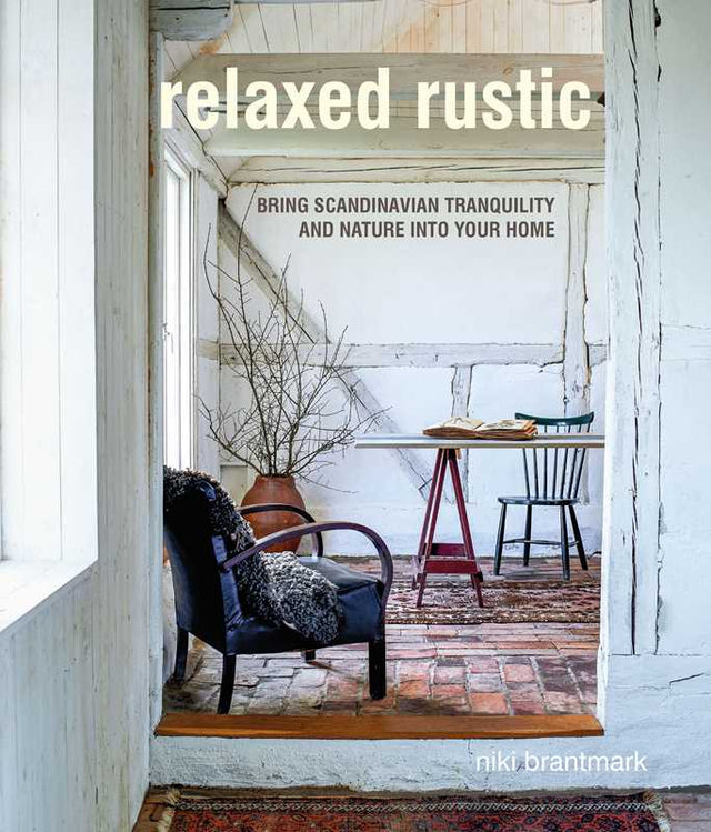 Book cover for Relaxed Rustic: Bring Scandinavian Tranquility & Nature into Your Home by Niki Brantmark, showcasing cozy interiors with exposed beams and a soothing neutral palette inspired by nature.