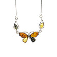 The Butterfly Multi Color Amber Silver Necklace features a sterling silver pendant with multicolor amber and green gemstones, accented by two teardrop-shaped gems, on an 18 delicate chain.