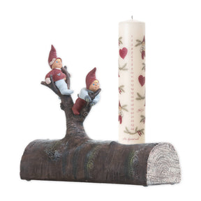 The Candle Holder: Tue & Trille Calendar Candle Holder features a log-shaped base with numbered calendar design and two gnome figurines climbing a tree, bringing Scandinavian Christmas charm to your holiday décor.