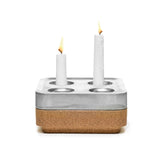 The Stumpastaken Fyran Four Candle Holder is a square, white powder-coated holder crafted from 100% recycled material, featuring Swedish design with four candle slots—perfect for sustainable decor.