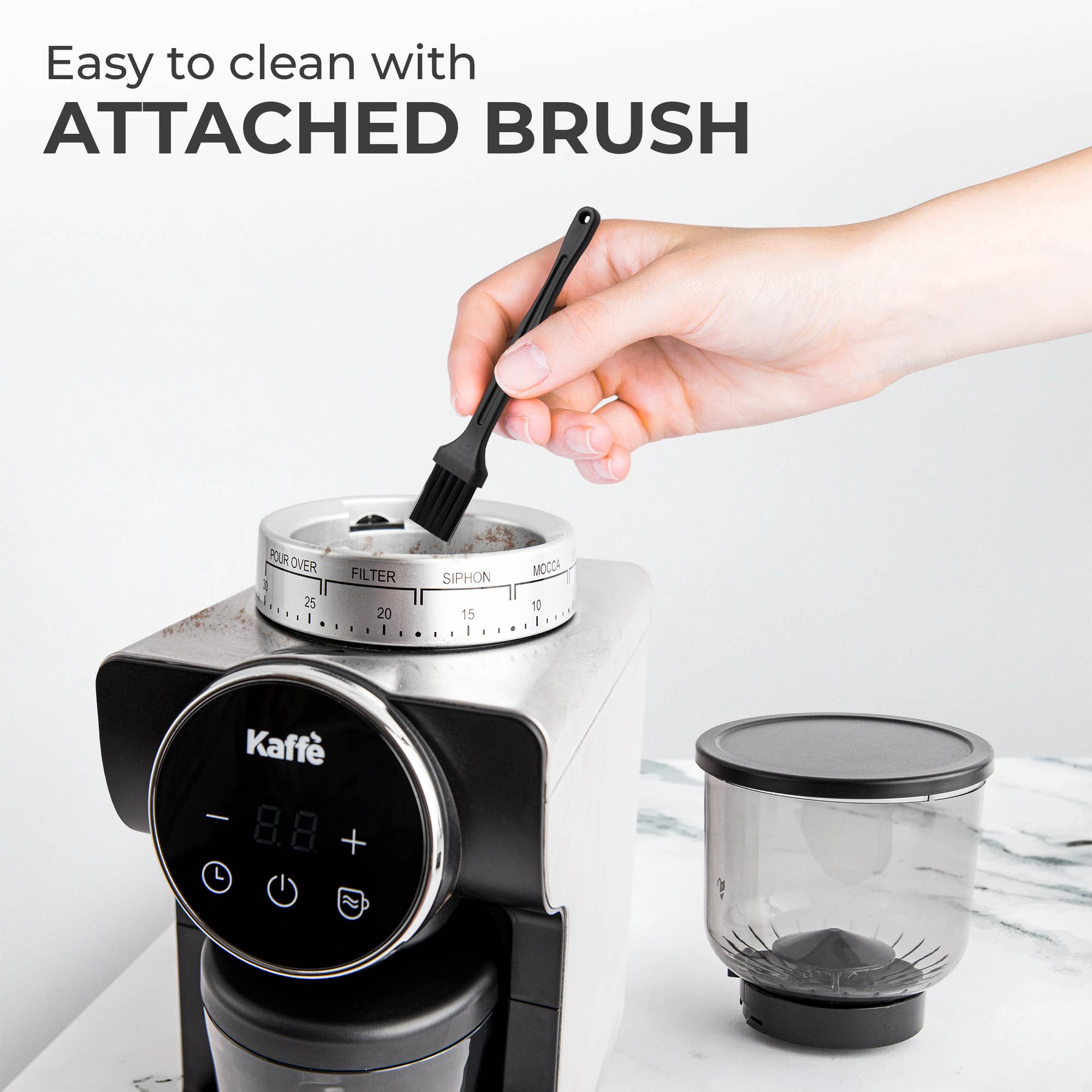A hand cleans the top of the Coffee Grinder: Electric Conical Burr Coffee Grinder – Precision Grinding with Digital Control using the attached brush. Text reads, Easy to clean with ATTACHED BRUSH.