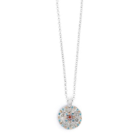 Part of the A&C Oslo Vibrance Collection, the Silver Coin Necklace features a round pendant with colorful stones on a delicate silver chain.