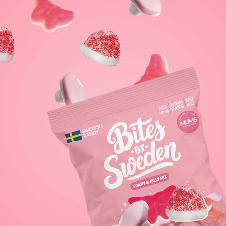 Pink bag labeled Bites by Sweden Foamy & Jelly Mix, with assorted pink and red gummy candies spilling out onto a pink background.